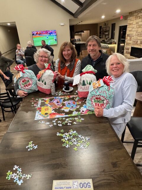 Residents working a puzzle during a community gathering at the Siesta Hills clubhouse in Mankato Minnesota